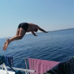 Diving from the deck of the sailboat Makeva